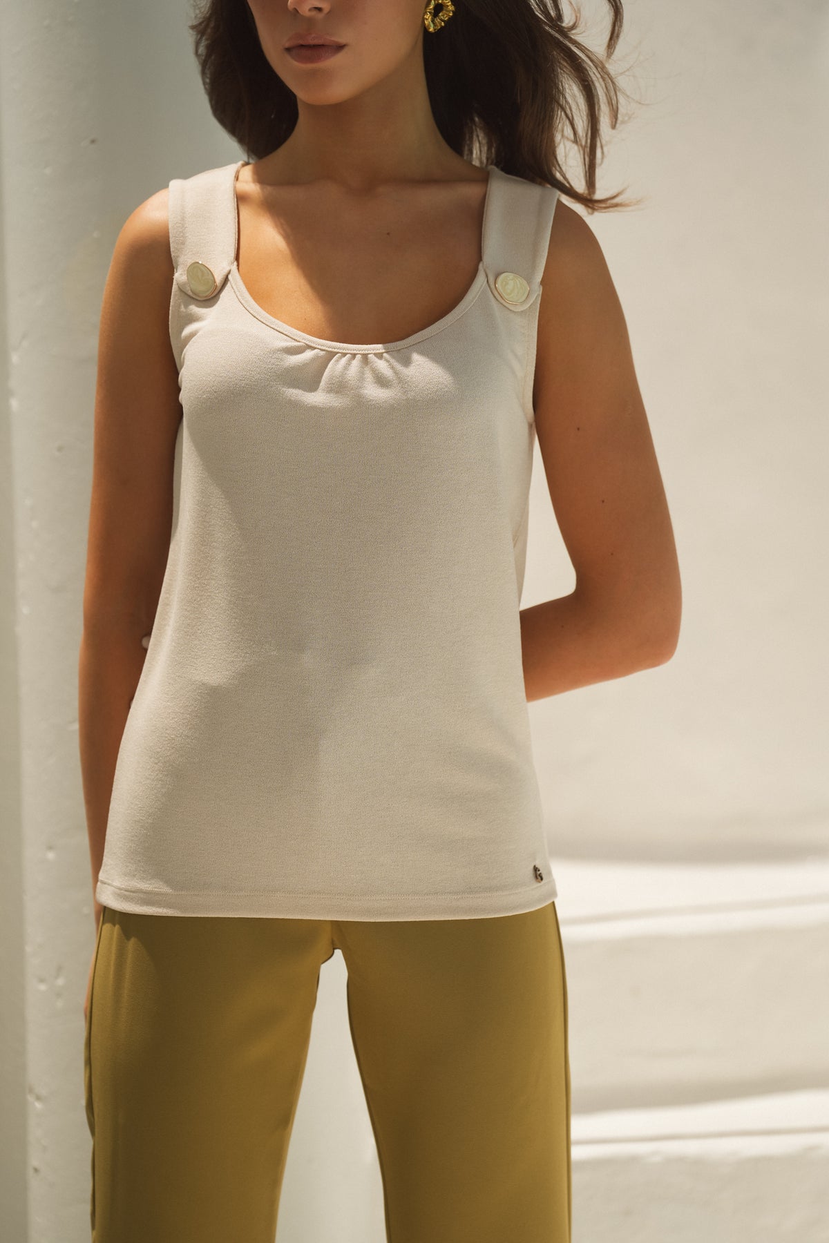 Top with decorative button on the shoulders.
